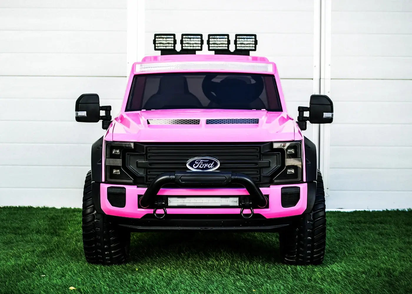 Kids ride on Ford truck in pink with off-road lights, perfect for adventurous playtime.